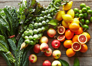 a group of fruits and vegetables on a wood surface Healthy Weight Loss Diets Berkhamsted