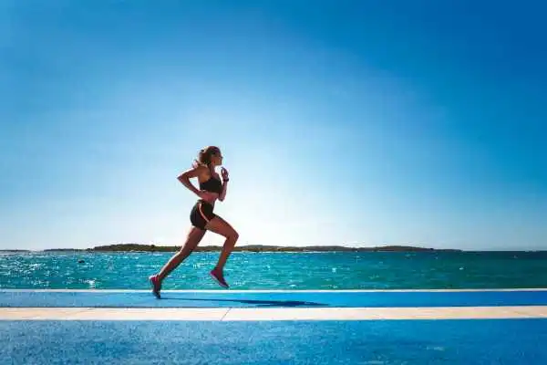 Woman running showing strong leg muscle Berkhamsted